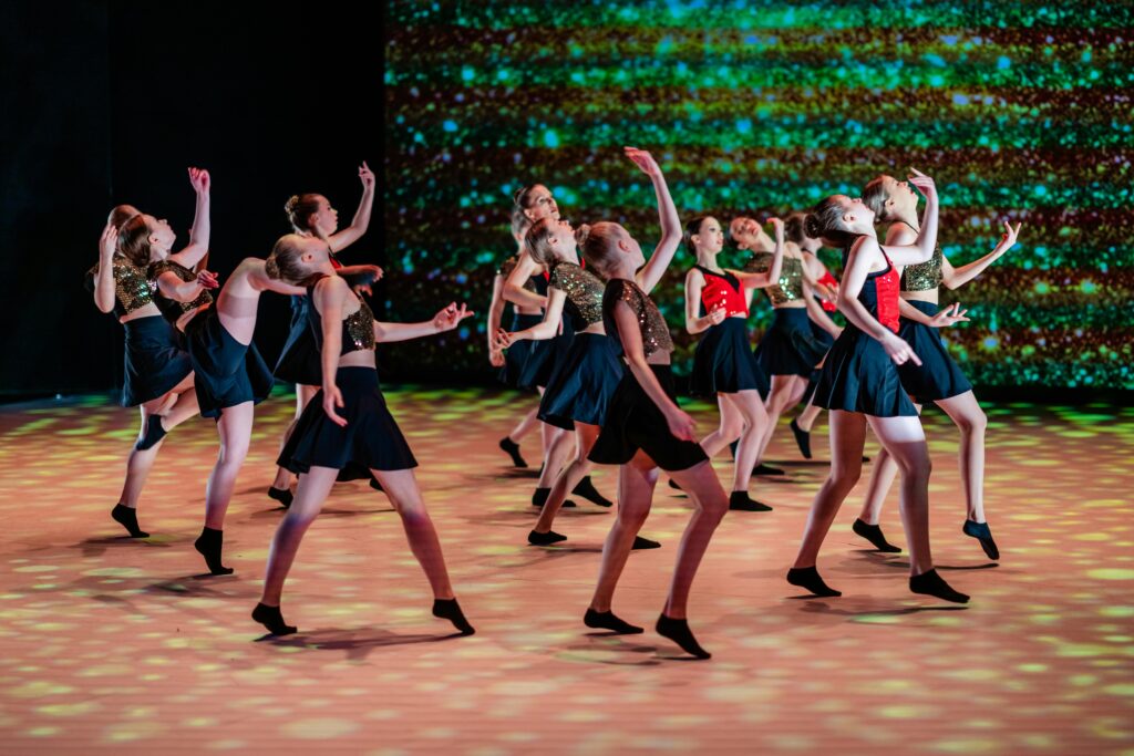Energetic dance group of young performers in a captivating stage show.